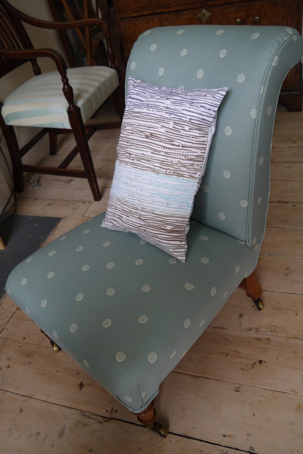 Ombre print cushion on white ticking fabric