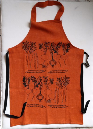 Orange linen apron printed with vegetable design